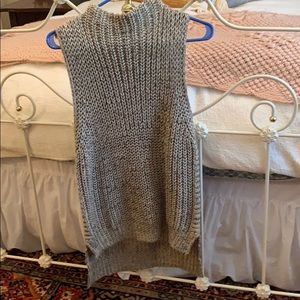 Tan sweater; turtleneck; sleeveless